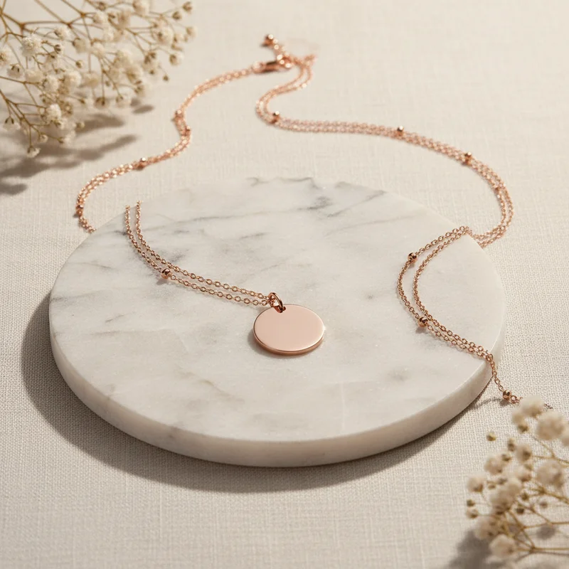 Rose gold necklace on marble