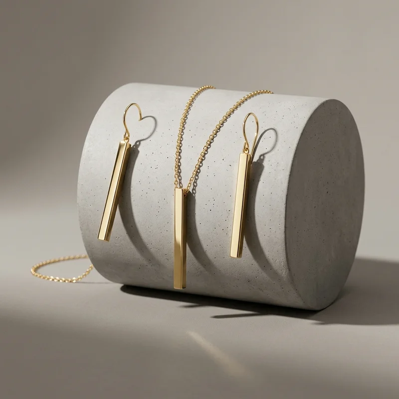 Minimalist gold jewelry on concrete