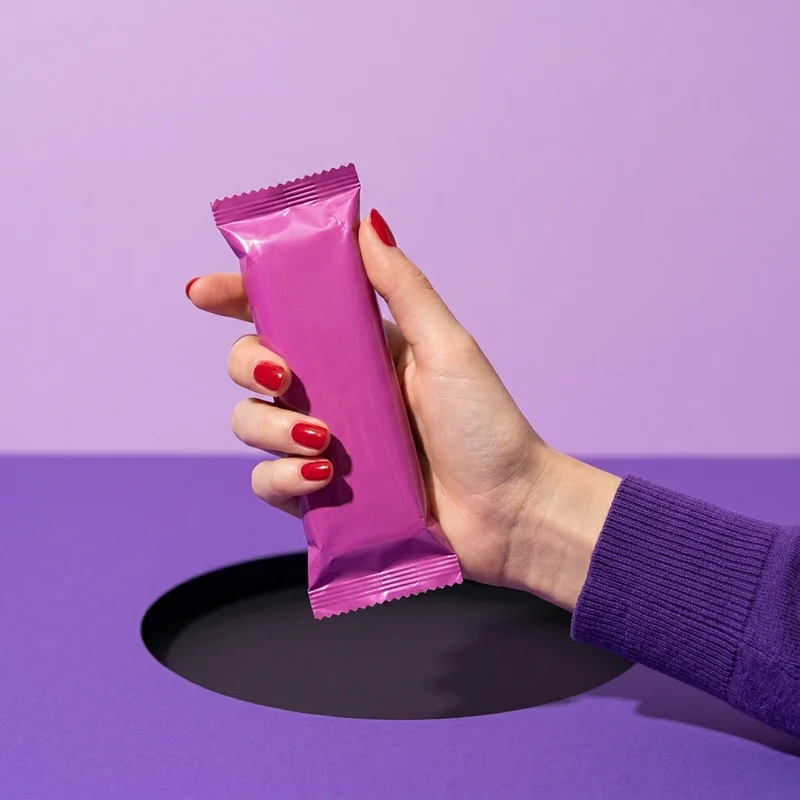 Pink snack bar in hand