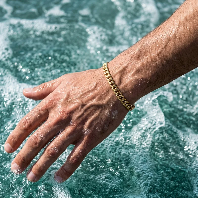 Men's gold curb bracelet in water