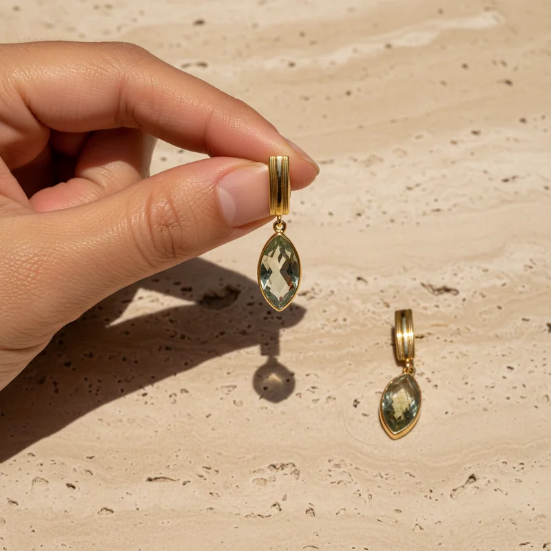 Elegant gold earrings on stone