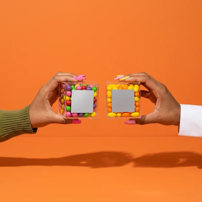 Colorful candy boxes held by hands