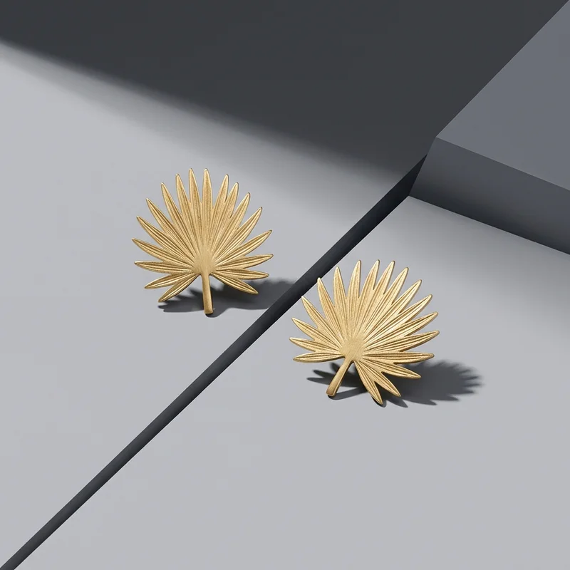 Gold leaf earrings on gray