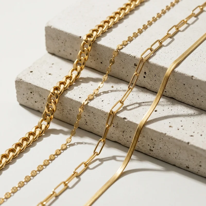 Layered gold chains on concrete