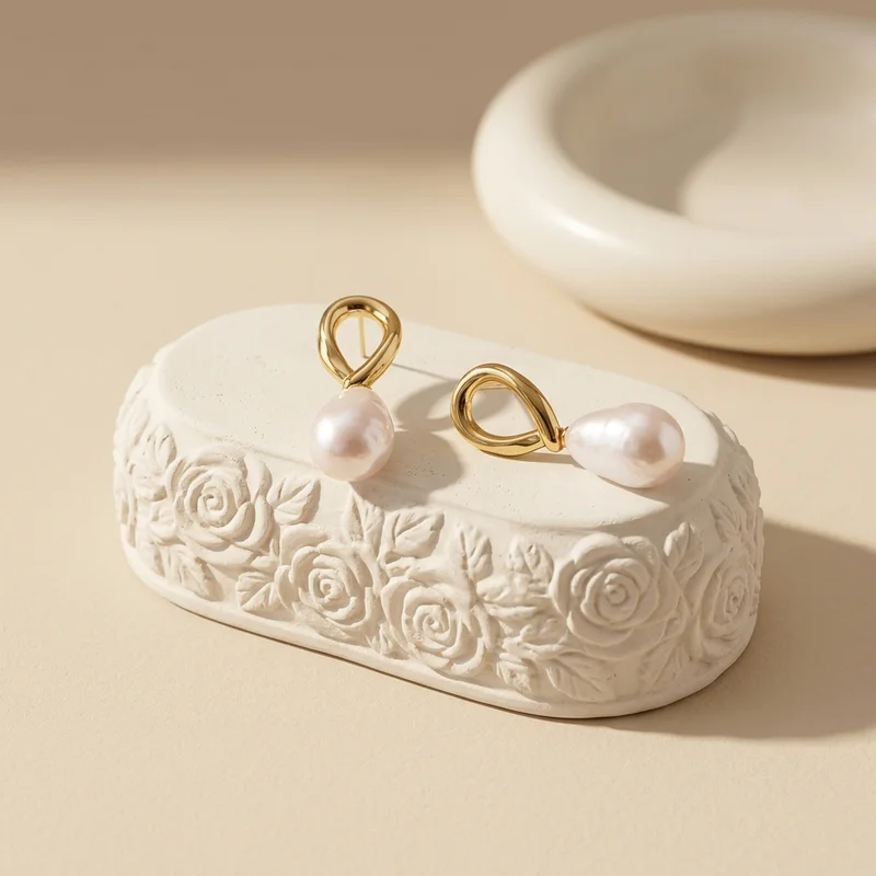 Elegant pearl earrings on textured stone