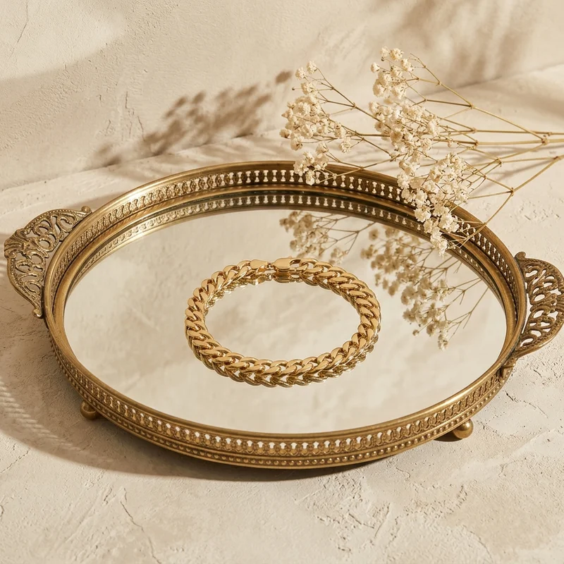 Vintage gold jewelry on mirror tray