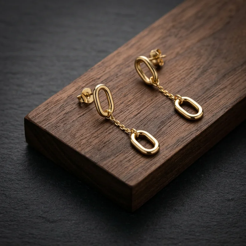 Elegant gold earrings on wood