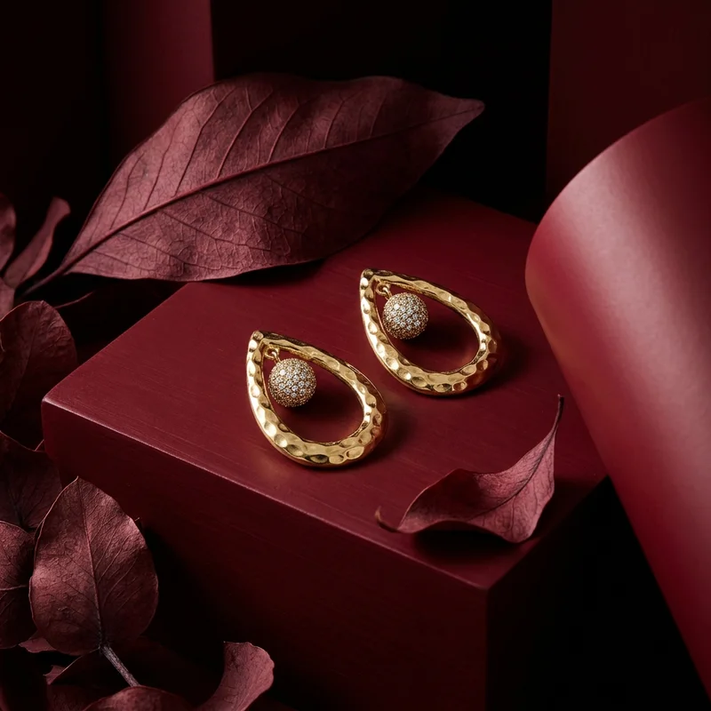 Elegant gold earrings on red wood
