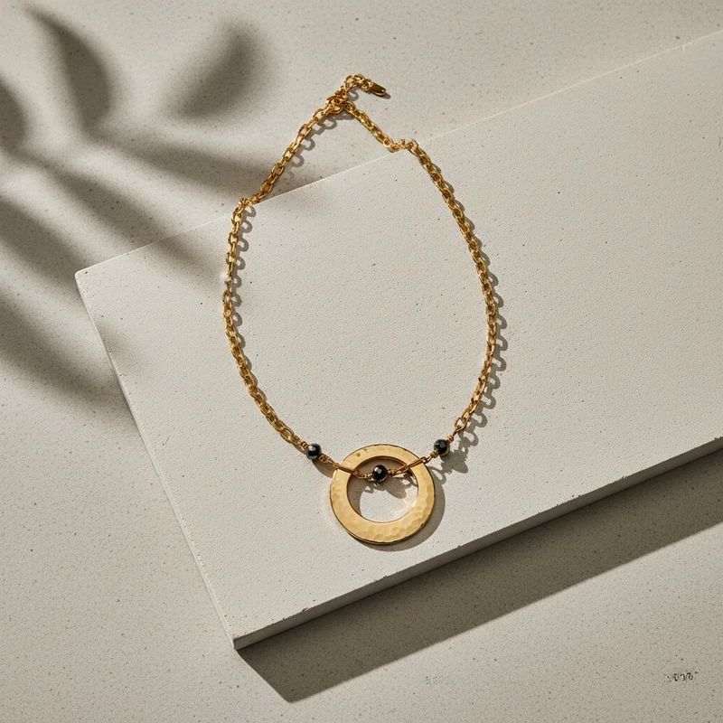 Modern gold necklace on concrete