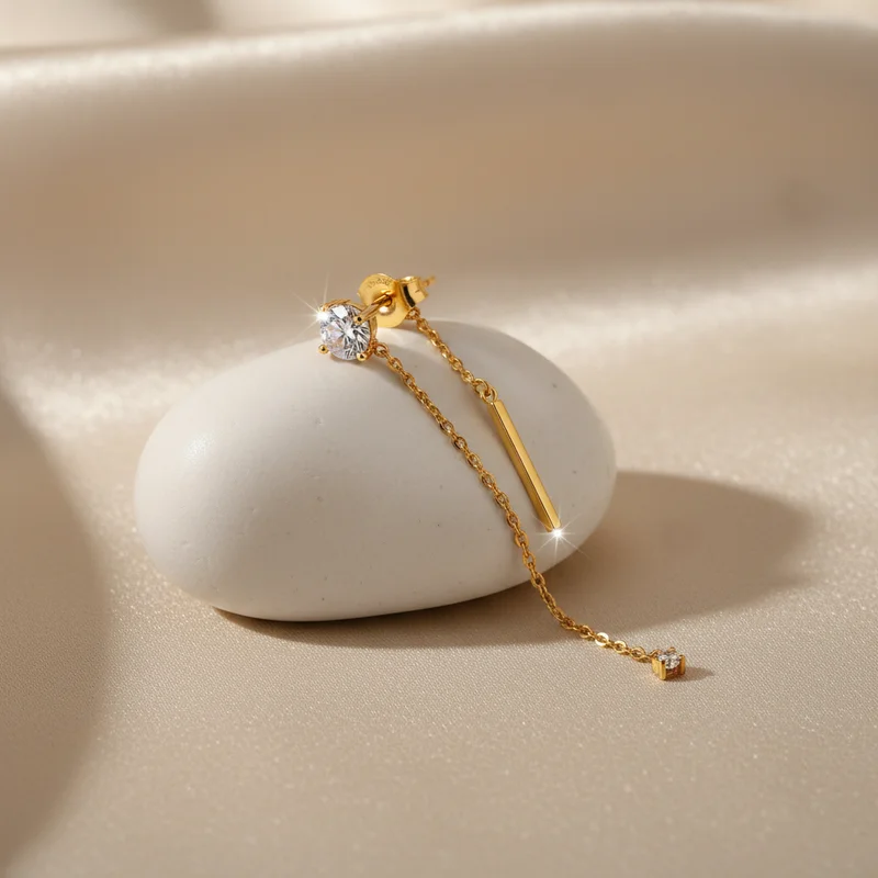 Elegant gold earring on pebble