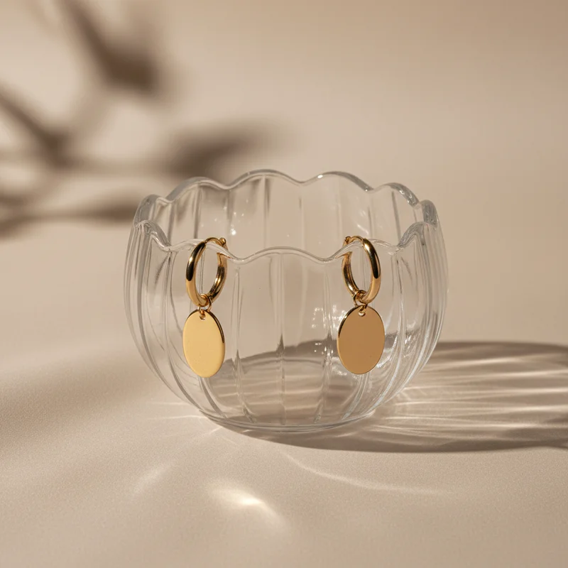 Gold earrings in glass bowl